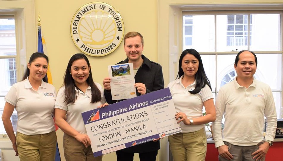 Adam Forman accepts his prize, winning a 7 night holiday in The Philippines